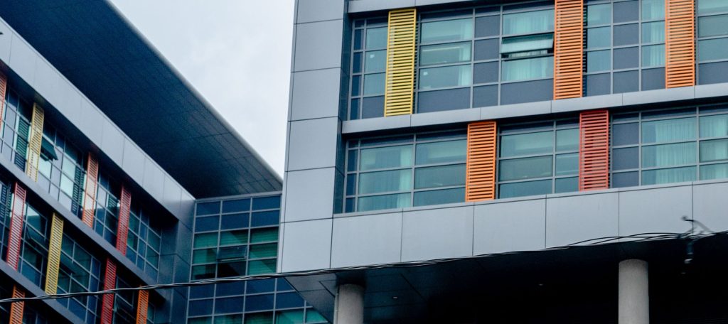 A modern commercial building with a colourful panelled and glazed facade