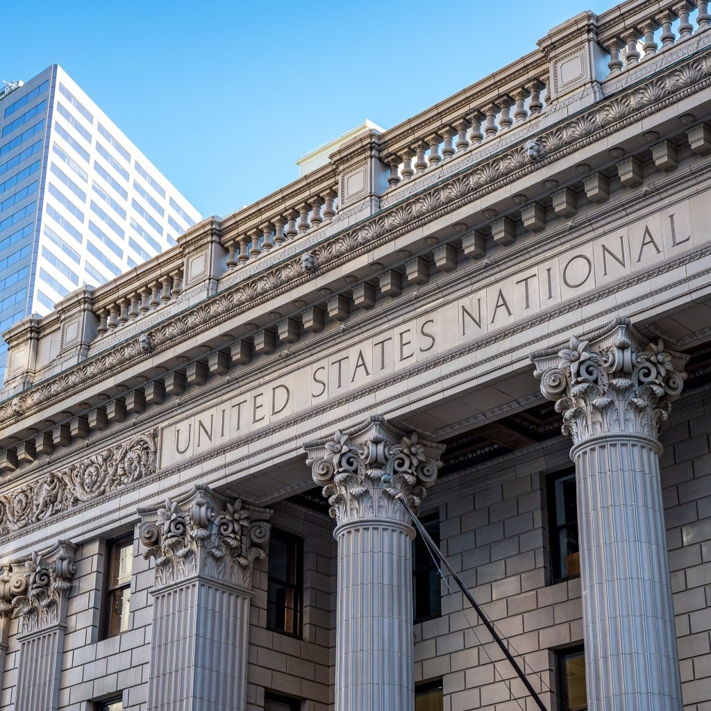 The columned stone facade and entrance of a historic bank building
